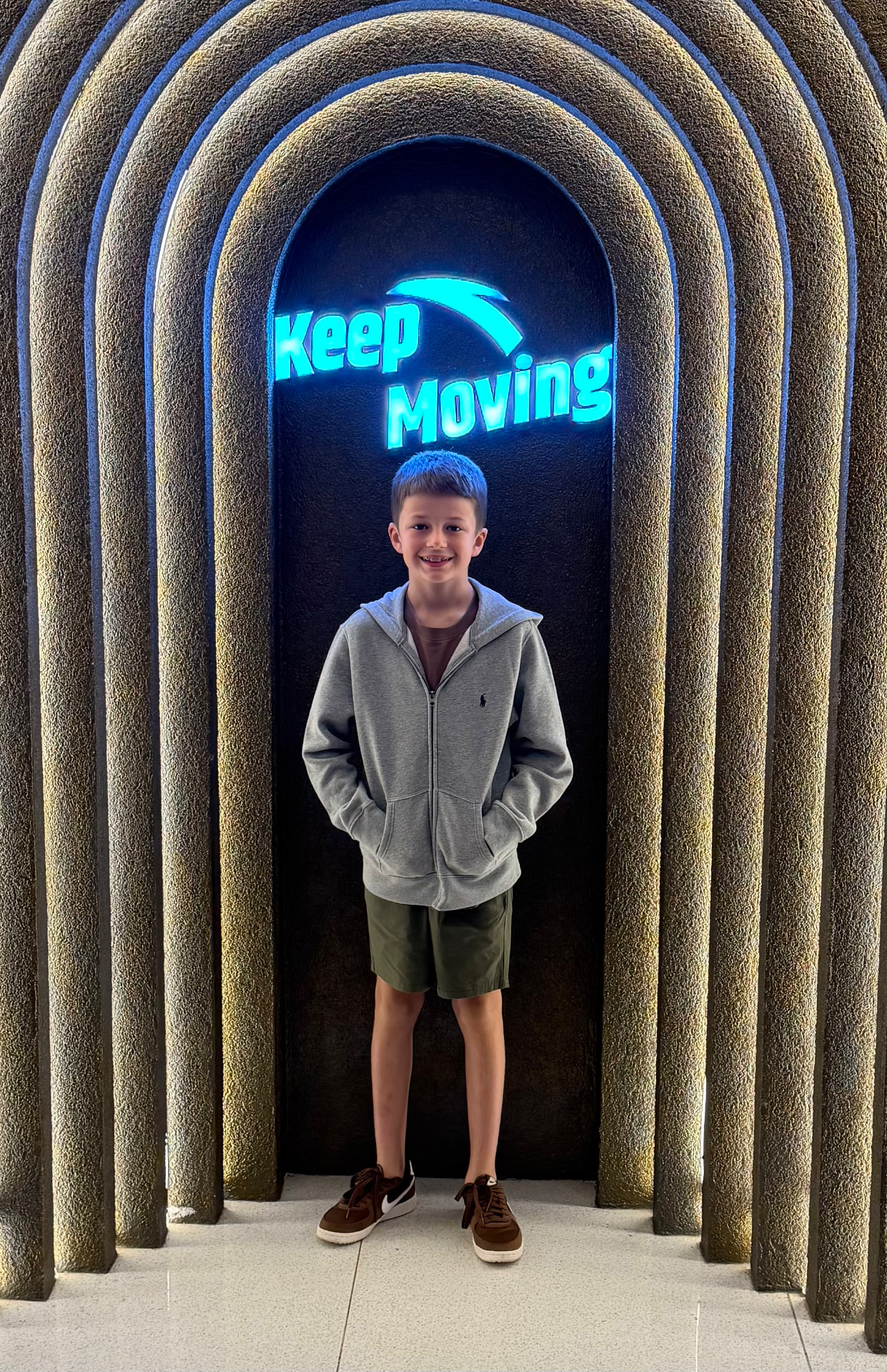 Harry, the young maker behind Printimals, standing in a lit archway